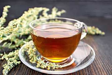 Image showing Tea with wormwood in glass cup on table