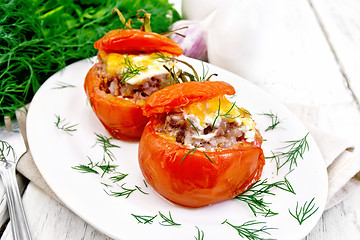 Image showing Tomatoes stuffed with meat and rice with dill in plate on board