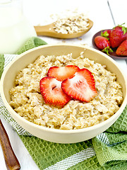 Image showing Oatmeal with strawberries on napkin