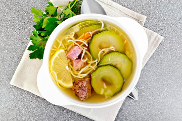 Image showing Soup with zucchini and noodles on granite table top