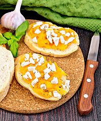 Image showing Bruschetta with pumpkin and cheese on dark board