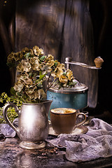 Image showing Flowes And Old Coffee Mill