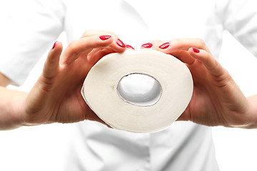 Image showing Hands beauticians squeeze roll of toilet paper .