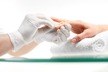 Image showing Nail polish remover, manicure Removal of nail varnish. manicure Beautician removes nail polish with a cotton ball soaked in acetone.