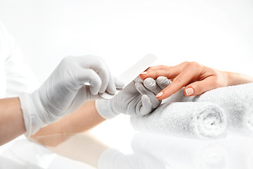 Image showing Sawing nails, manicure . Treatment hand and nail care, the woman to a beautician for a manicure.