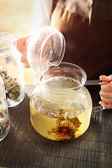 Image showing Blooming tea brewed in a glass jug. Blooming tea.