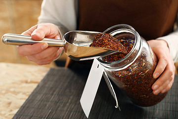 Image showing Tea room, a woman buys fruit tea