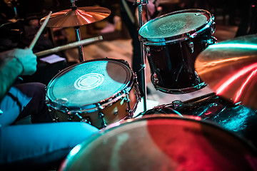 Image showing Drummer playing on drum set on stage.