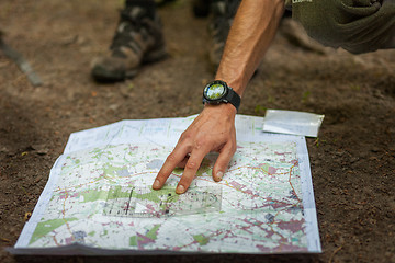 Image showing Navigating with map and compass