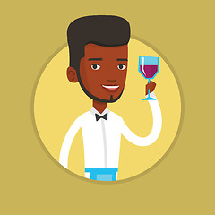 Image showing Bartender holding a glass of wine in hand.