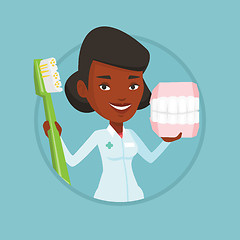 Image showing Dentist with dental jaw model and toothbrush.