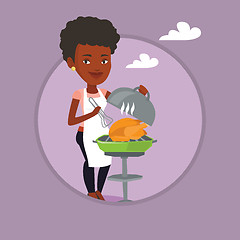 Image showing Woman cooking chicken on barbecue grill.