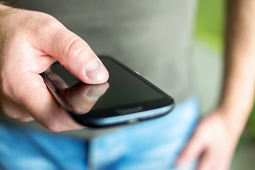 Image showing Hand of man with a smartphone