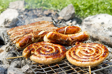 Image showing sausages on grill outdoor
