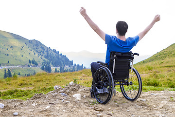 Image showing optimistic handicapped man sitting on wheelchair