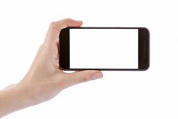 Image showing Hand holding black smart phone isolated on white