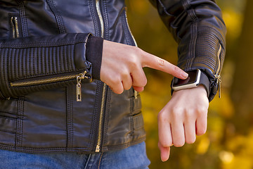 Image showing Teenager girl Using touchscreen smart watch