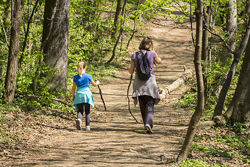 Image showing Mother and daughter walking in spring forest