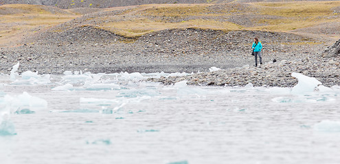 Image showing Woman walking over the beach at Jokulsarlon glacier lagoon - Ice