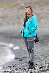 Image showing Woman walking over the beach at Jokulsarlon glacier lagoon - Ice