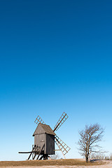 Image showing Old wooden windmill on a hill