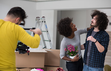 Image showing multiethnic couple moving into a new home