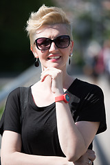 Image showing young woman with short blond hair and sunglasses