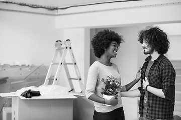 Image showing multiethnic couple moving into a new home