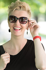 Image showing young woman with short blond hair and sunglasses