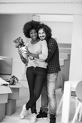 Image showing multiethnic couple moving into a new home