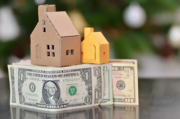 Image showing Miniature paper made house stand on  money