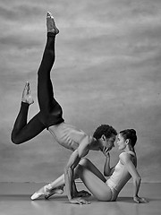 Image showing Couple of ballet dancers posing over gray background