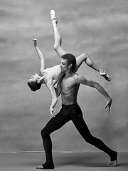 Image showing Couple of ballet dancers posing over gray background