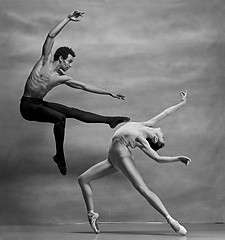 Image showing Couple of ballet dancers posing over gray background