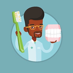 Image showing Dentist with dental jaw model and toothbrush.