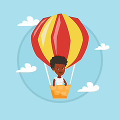 Image showing Young woman flying in hot air balloon.