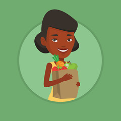 Image showing Happy woman holding grocery shopping bag.