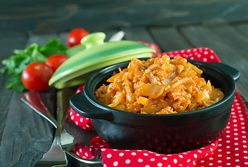 Image showing fried cabbage in bowl and on a table