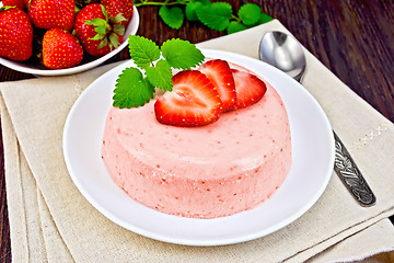 Image showing Panna cotta strawberry with mint on dark board