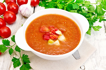 Image showing Soup tomato in white bowl on light board