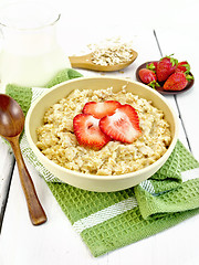 Image showing Oatmeal with strawberries on green napkin