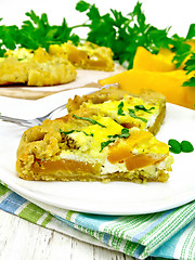 Image showing Pie of pumpkin and basil in plate on napkin