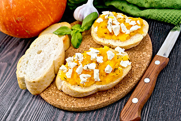 Image showing Bruschetta with pumpkin and feta on dark board