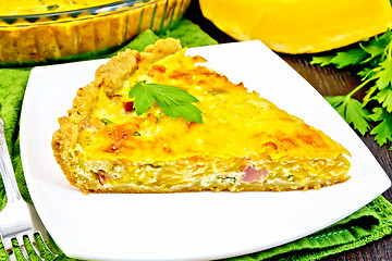 Image showing Quiche with pumpkin and bacon in plate on towel