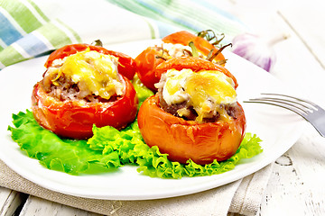 Image showing Tomatoes stuffed with rice and meat in plate on light board