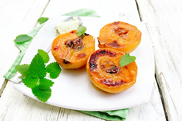 Image showing Quince baked with ice cream in plate on green napkin