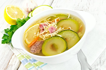 Image showing Soup with zucchini and noodles on board