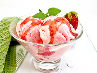 Image showing Ice cream strawberry with syrup in glass on light board