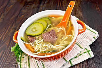 Image showing Soup with zucchini and noodles in bowl on towel