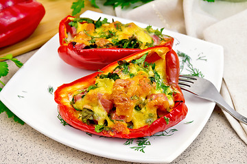 Image showing Pepper stuffed with sausage and cheese in white plate on table